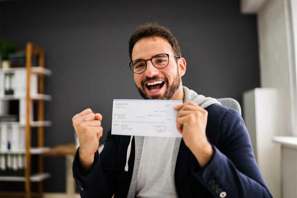 Man holding pay check