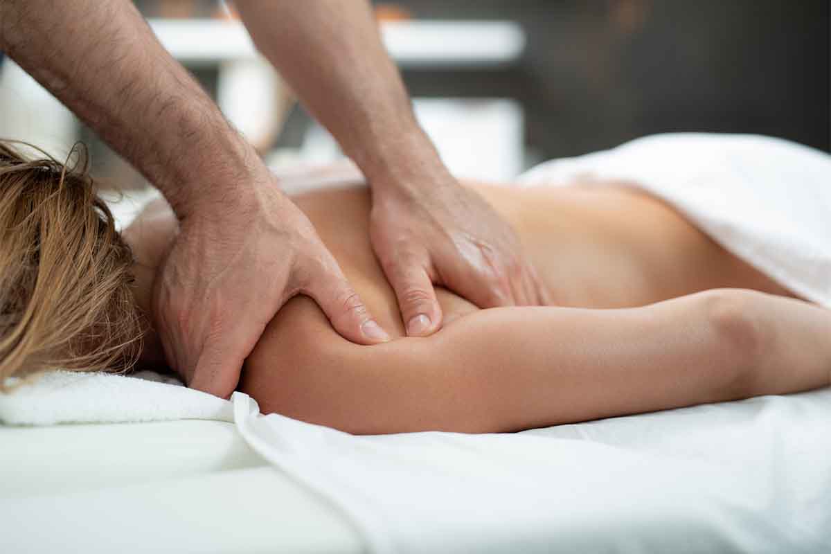 Woman receiving a therapeutic shoulder massage
